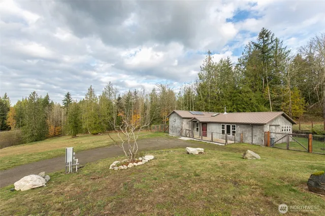a large kitchen with kitchen island a large window a sink and appliances