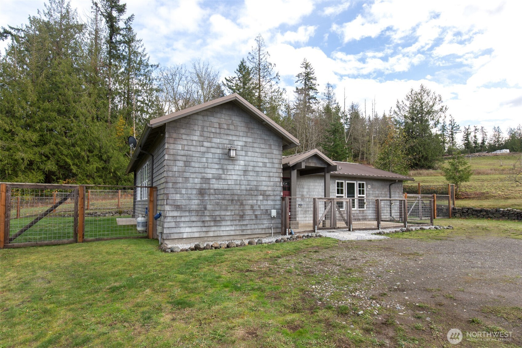 1083 Blyn Springs Road Sequim, WA 98382 - Photo 19 of 40 a front view of a house with a garden
