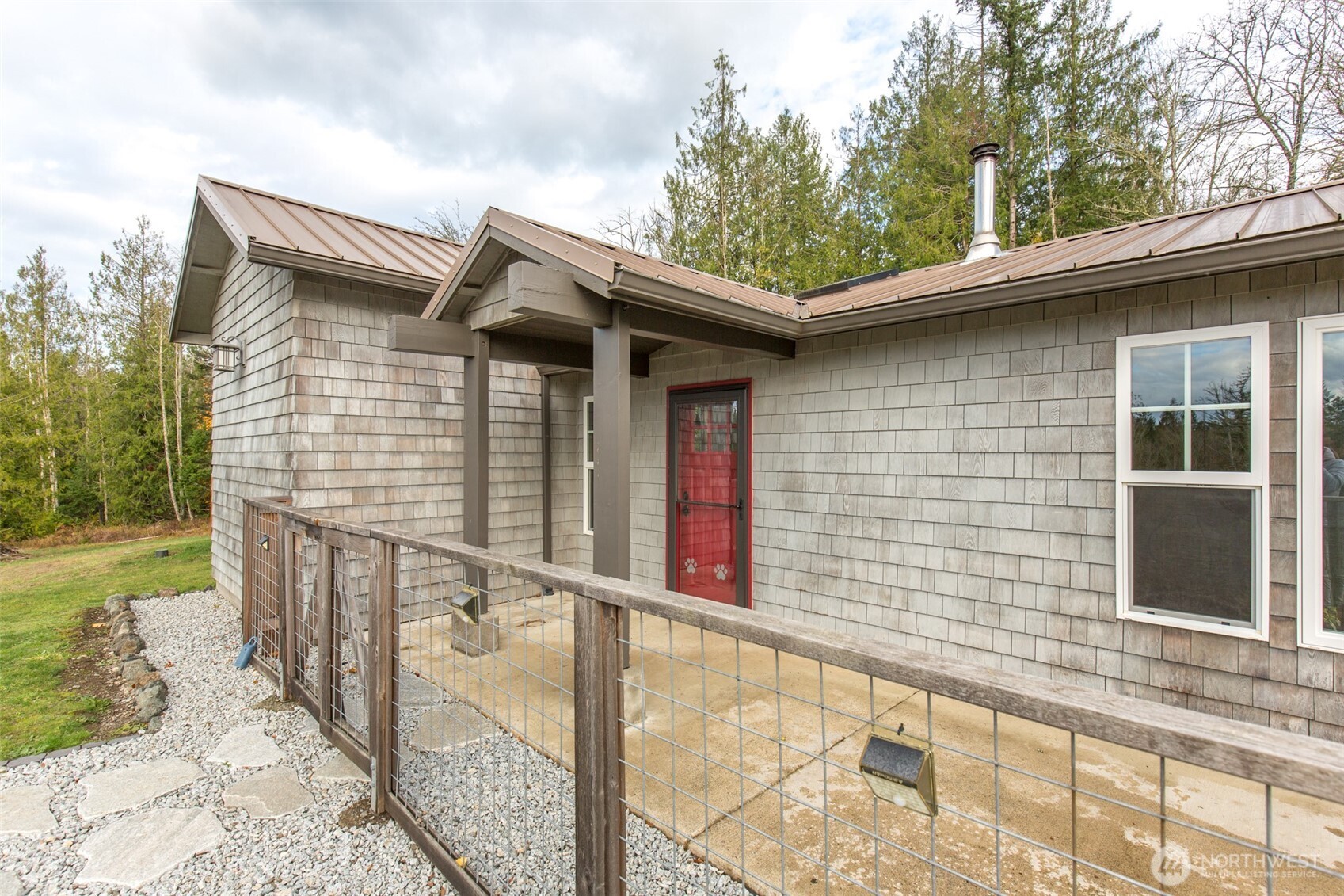 1083 Blyn Springs Road Sequim, WA 98382 - Photo 21 of 40 a view of a house with large windows