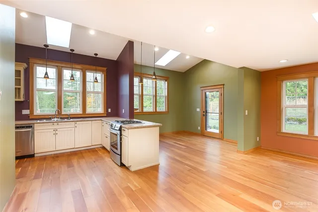a view of kitchen with sink and refrigerator