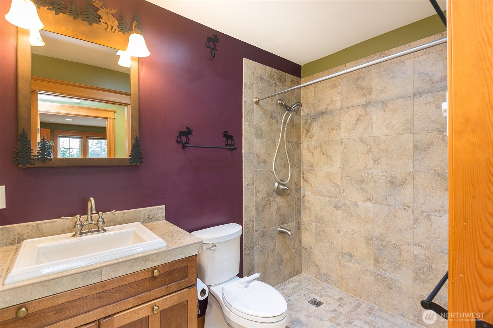 1083 Blyn Springs Road Sequim, WA 98382 - Photo 32 of 40 a bathroom with a sink mirror vanity and toilet