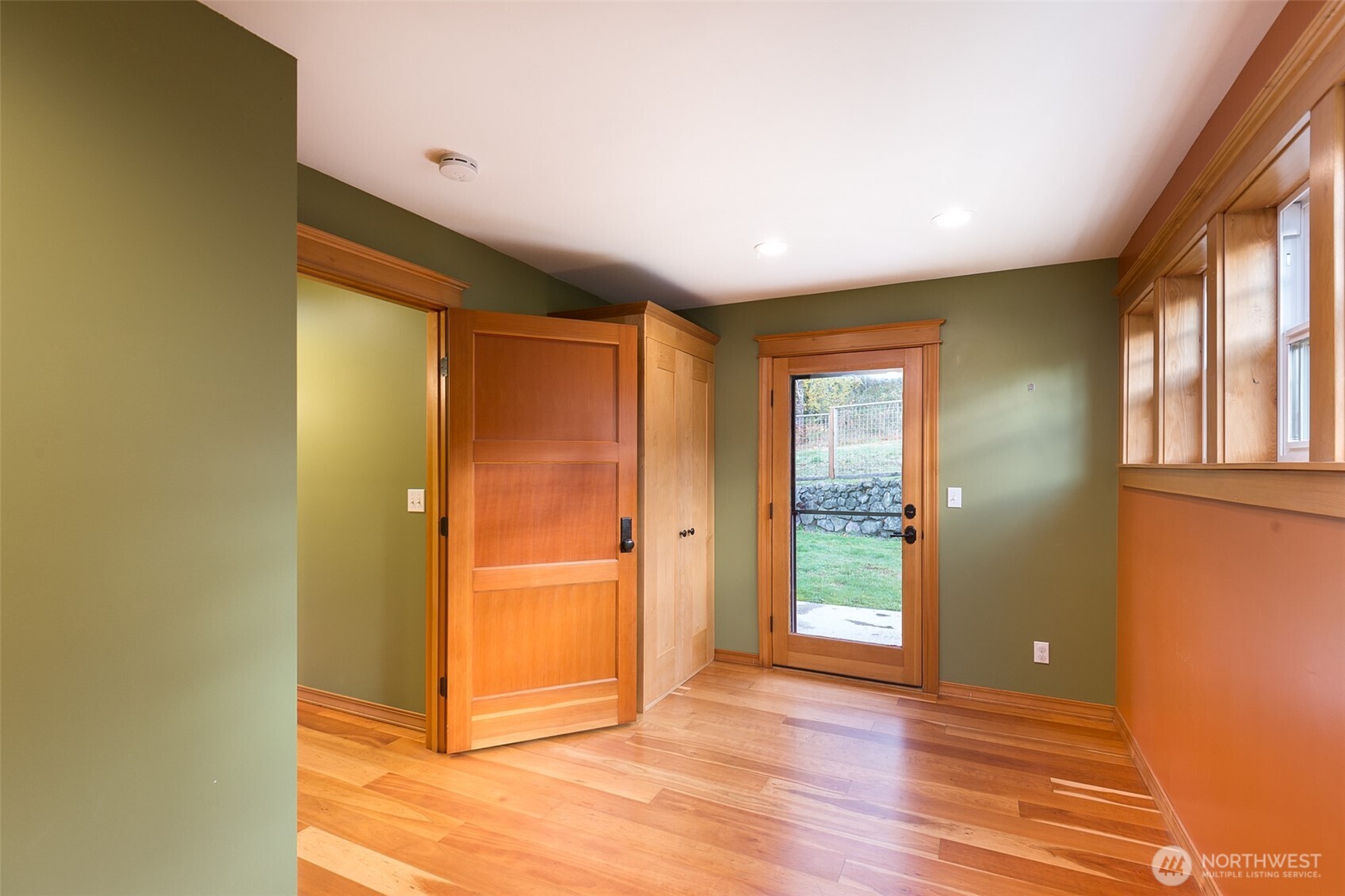 1083 Blyn Springs Road Sequim, WA 98382 - Photo 36 of 40 an empty room with wooden floor and windows