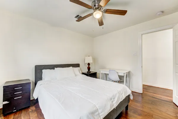 a bedroom with a bed and a window