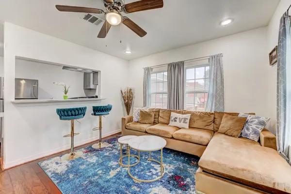 a living room with furniture and a rug