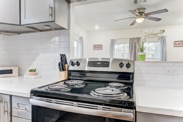 a kitchen with stainless steel appliances a sink stove and cabinets