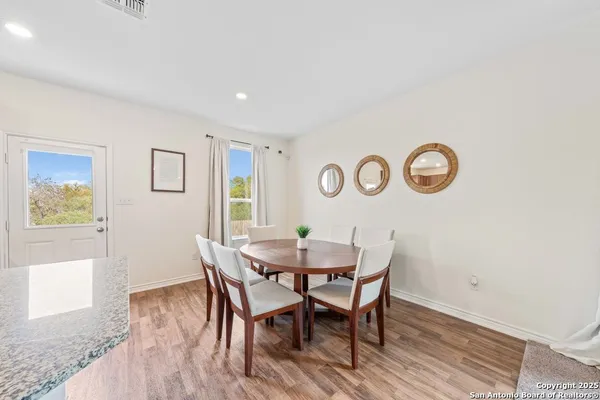 a view of a dining room with furniture and wooden floor