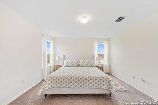 a bedroom with a bed and a night stand