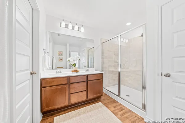 a bathroom with a shower sink and mirror