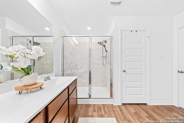 a bathroom with a sink a vanity and a shower