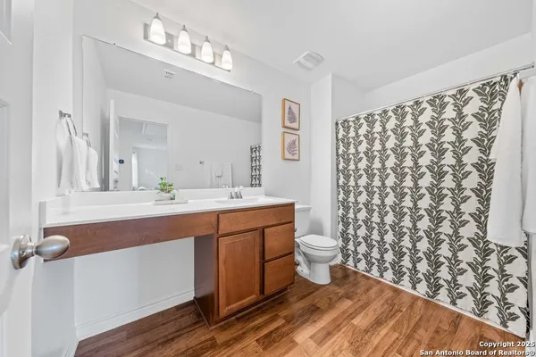 a spacious bathroom with a double vanity sink mirror and shower