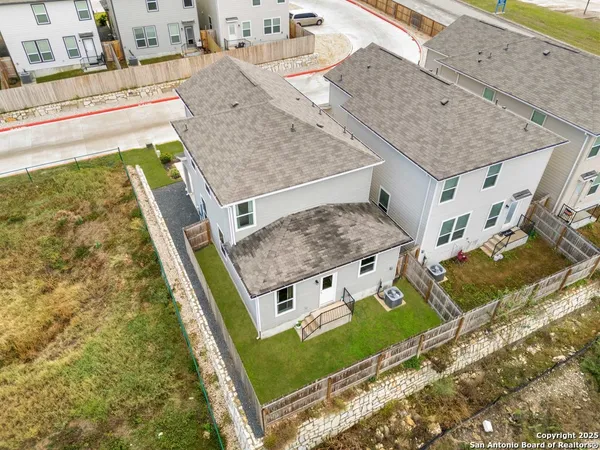 an aerial view of a house with a swimming pool