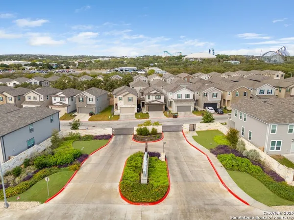 an aerial view of a house with garden space and street view