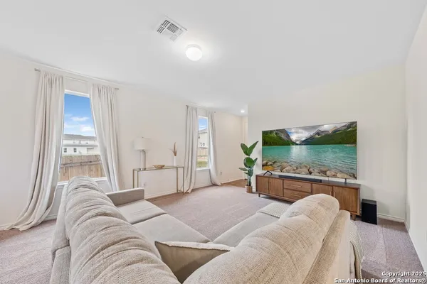 a bedroom with a large bed and a flat screen tv