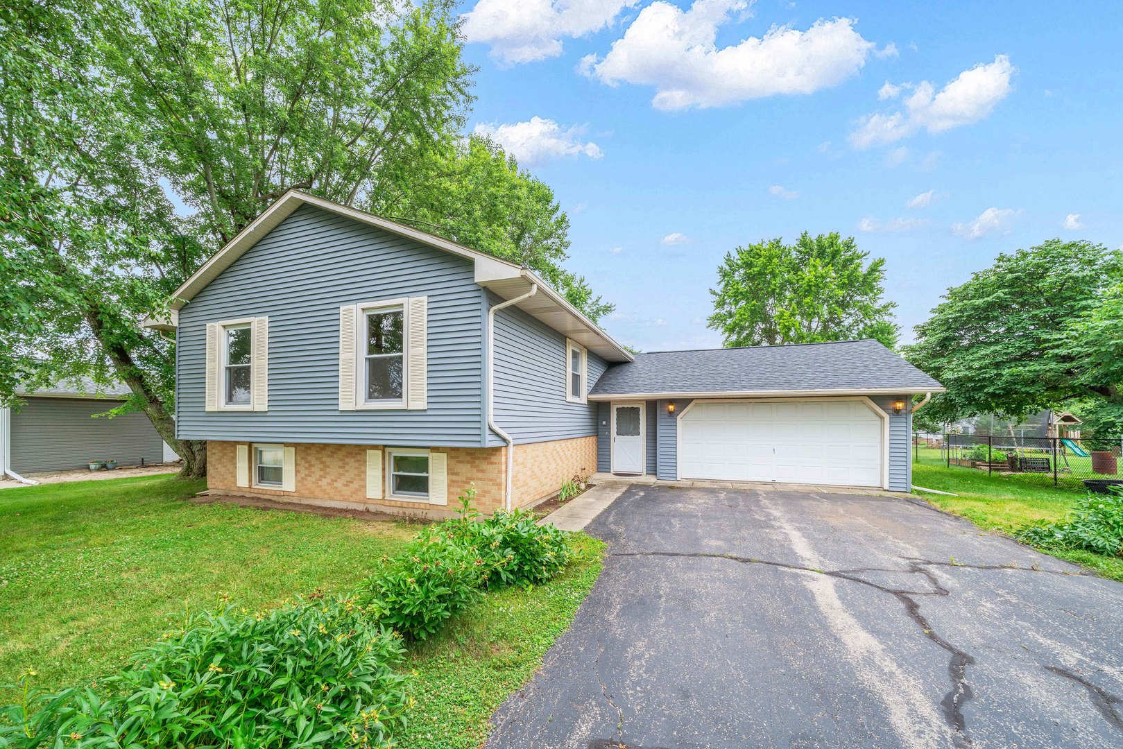 17624 Frazier Road Sandwich, IL 60548 - Photo 1 of 22 a front view of a house with a yard and garage