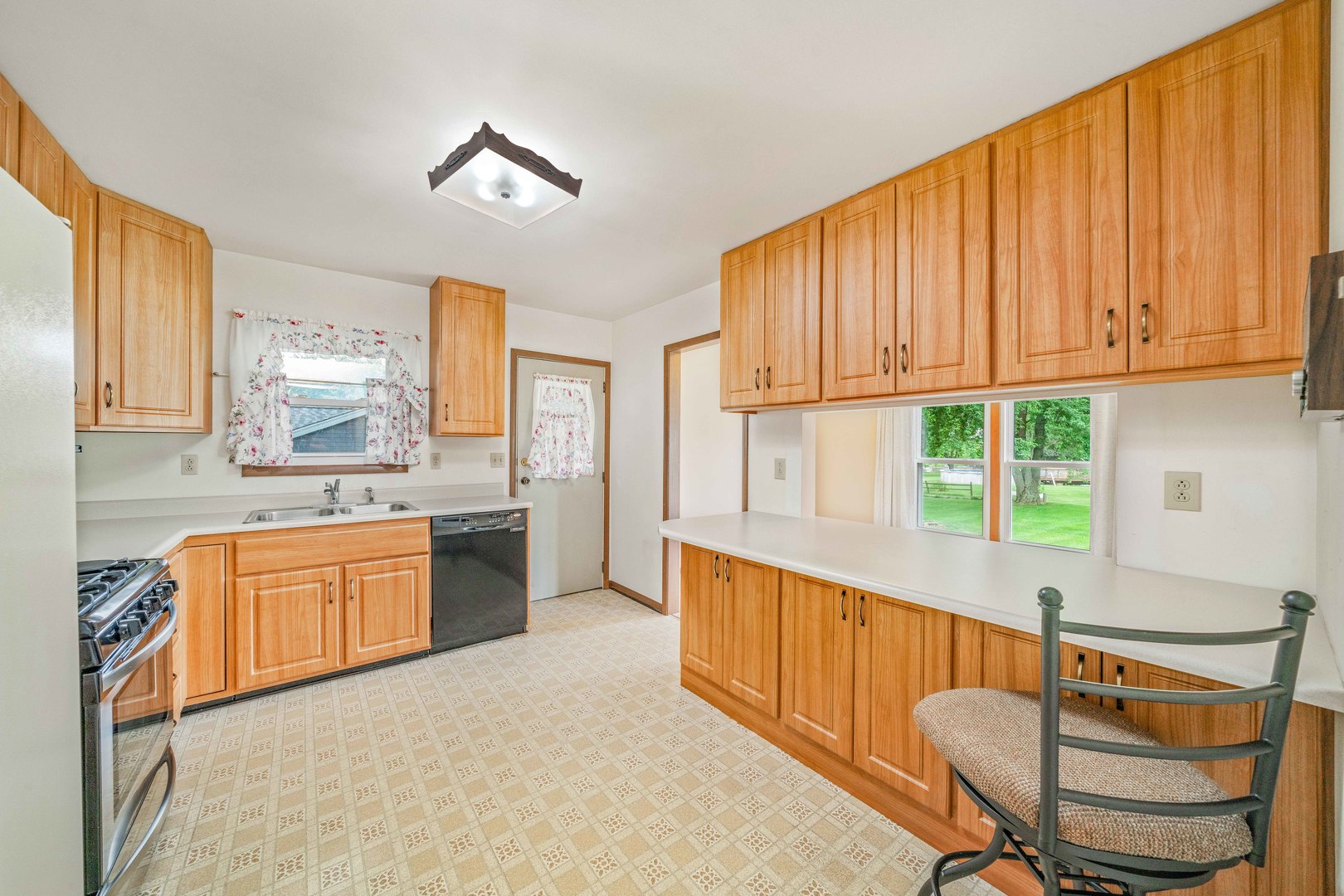 17624 Frazier Road Sandwich, IL 60548 - Photo 3 of 22 a kitchen with stainless steel appliances granite countertop a sink cabinets and a large window