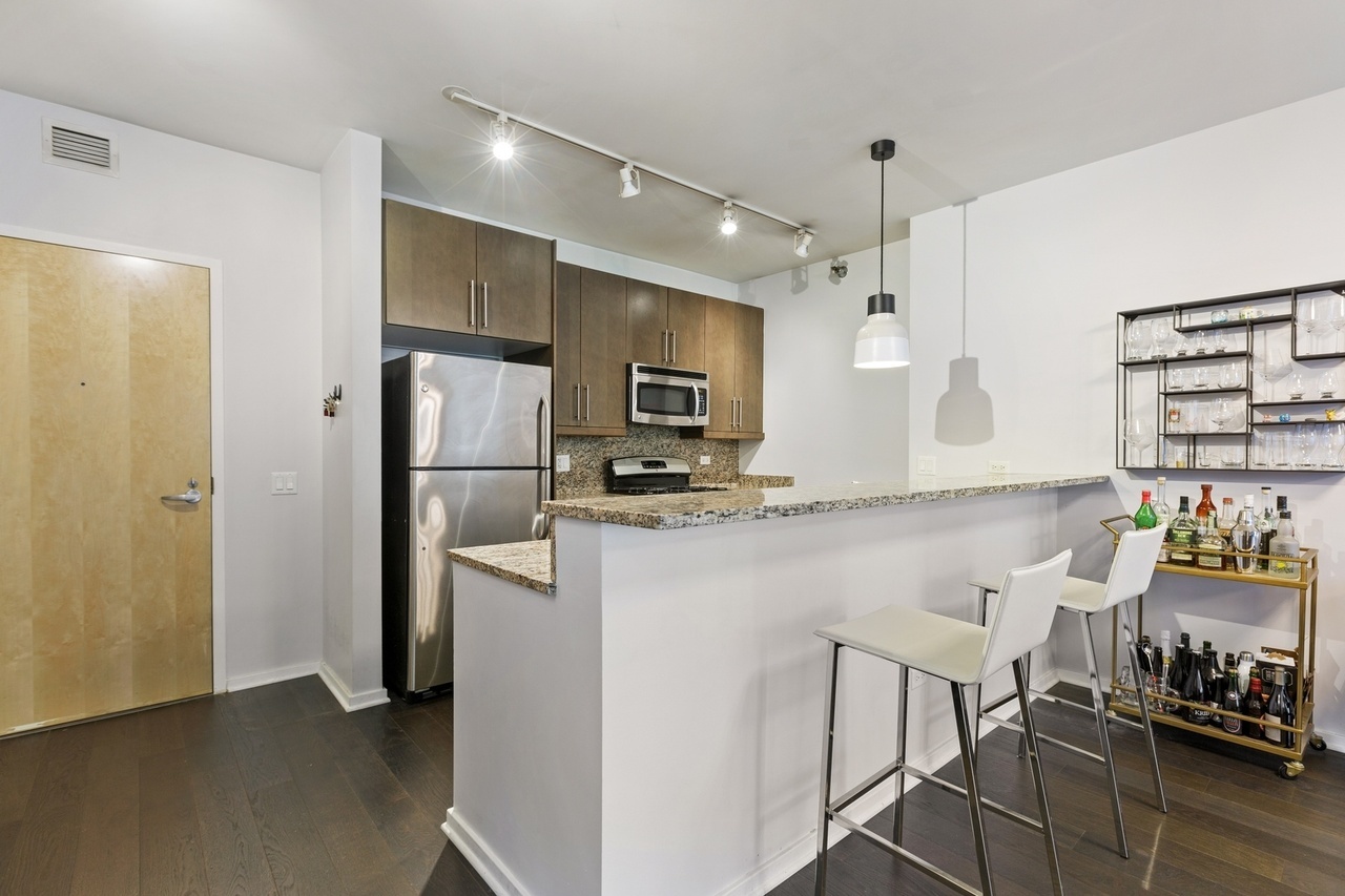 Undisclosed Address Chicago, IL 60607 - Photo 2 of 13 a kitchen with stainless steel appliances granite countertop a refrigerator and a stove top oven