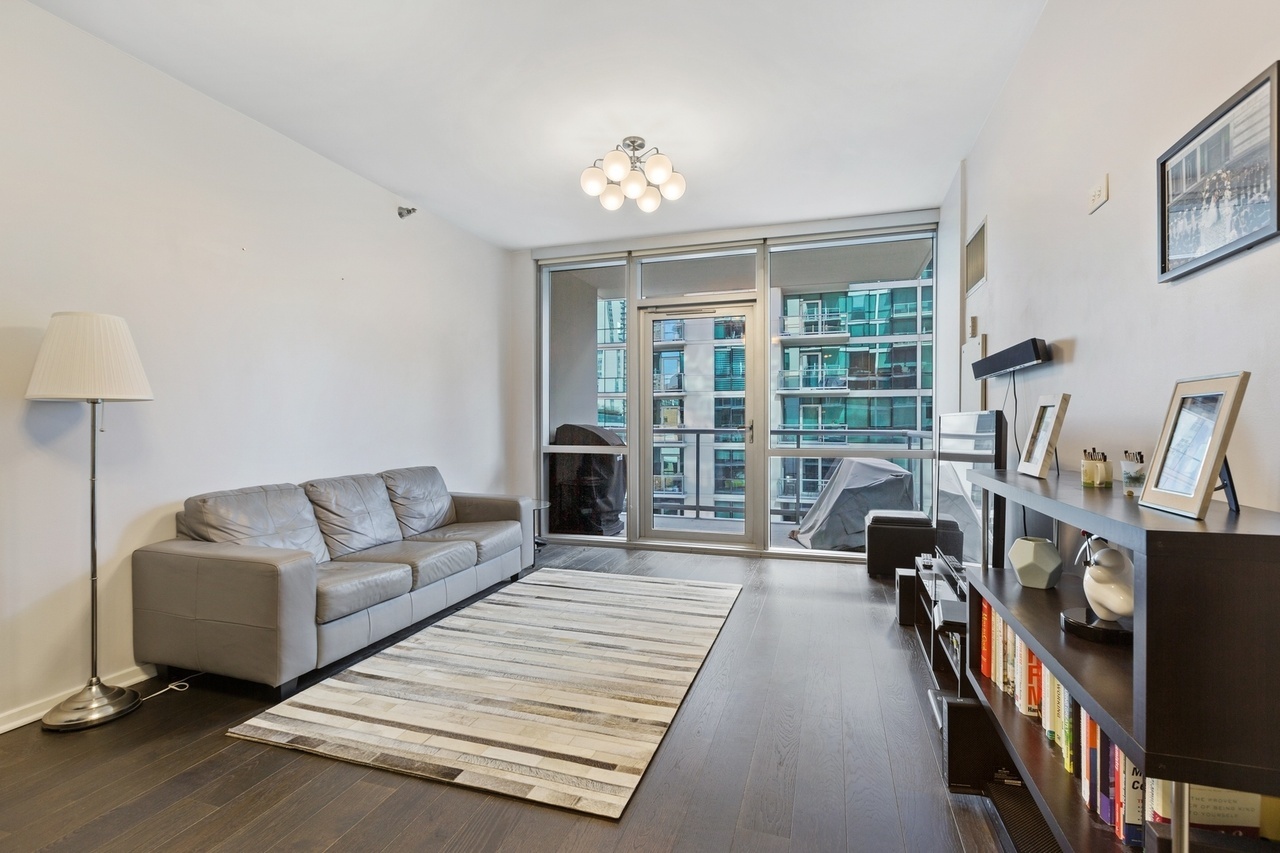 Undisclosed Address Chicago, IL 60607 - Photo 4 of 13 a living room with furniture and a chandelier
