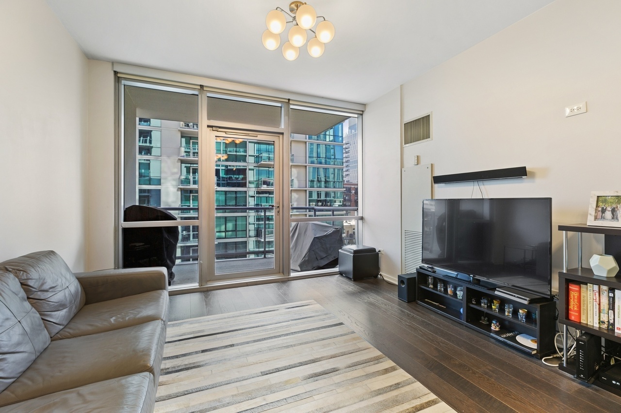 Undisclosed Address Chicago, IL 60607 - Photo 7 of 13 a living room with furniture and a flat screen tv