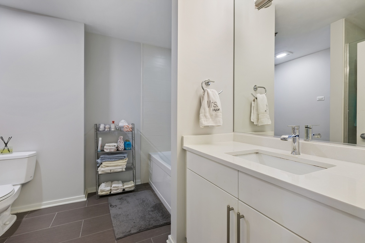 Undisclosed Address Chicago, IL 60607 - Photo 9 of 13 a bathroom with a sink and a mirror