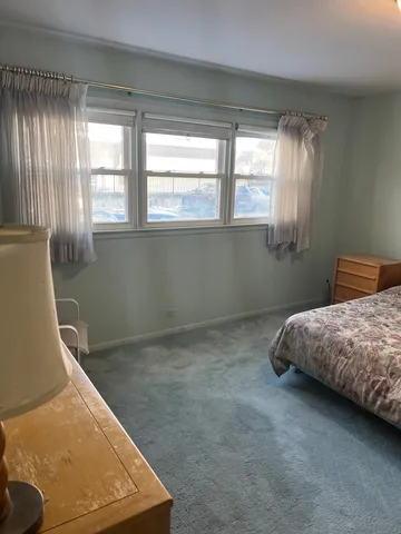 a bedroom with bed and window
