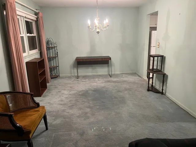 a kitchen with a table chairs refrigerator and microwave