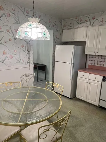 a view of a livingroom with a chandelier fireplace and a window