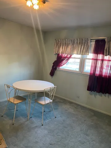 a bathroom with a granite countertop sink a toilet a mirror and bathtub