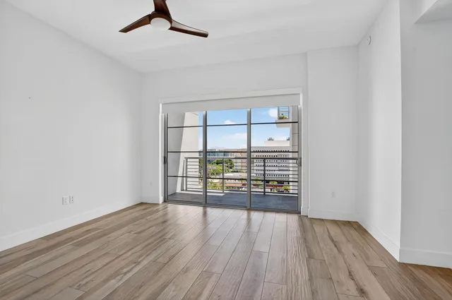 a view of an empty room and wooden floor