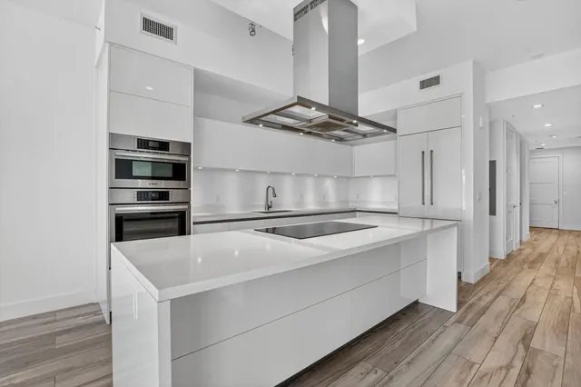 a white bath tub sitting next to a shower