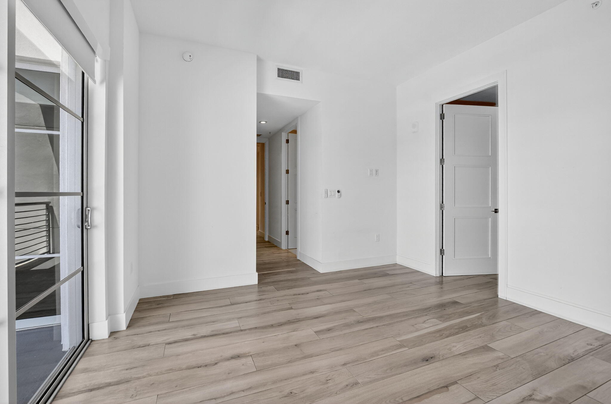 155 East Boca Raton Road, Unit 1014 Boca Raton, FL 33432 - Photo 32 of 62 a view of an empty room with wooden floor and a window