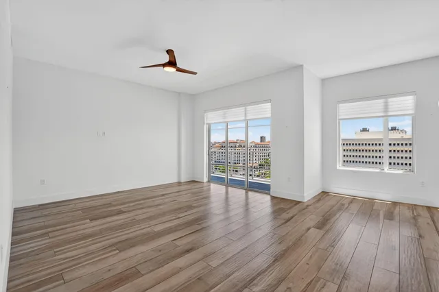 a view of a room with wooden floor and window