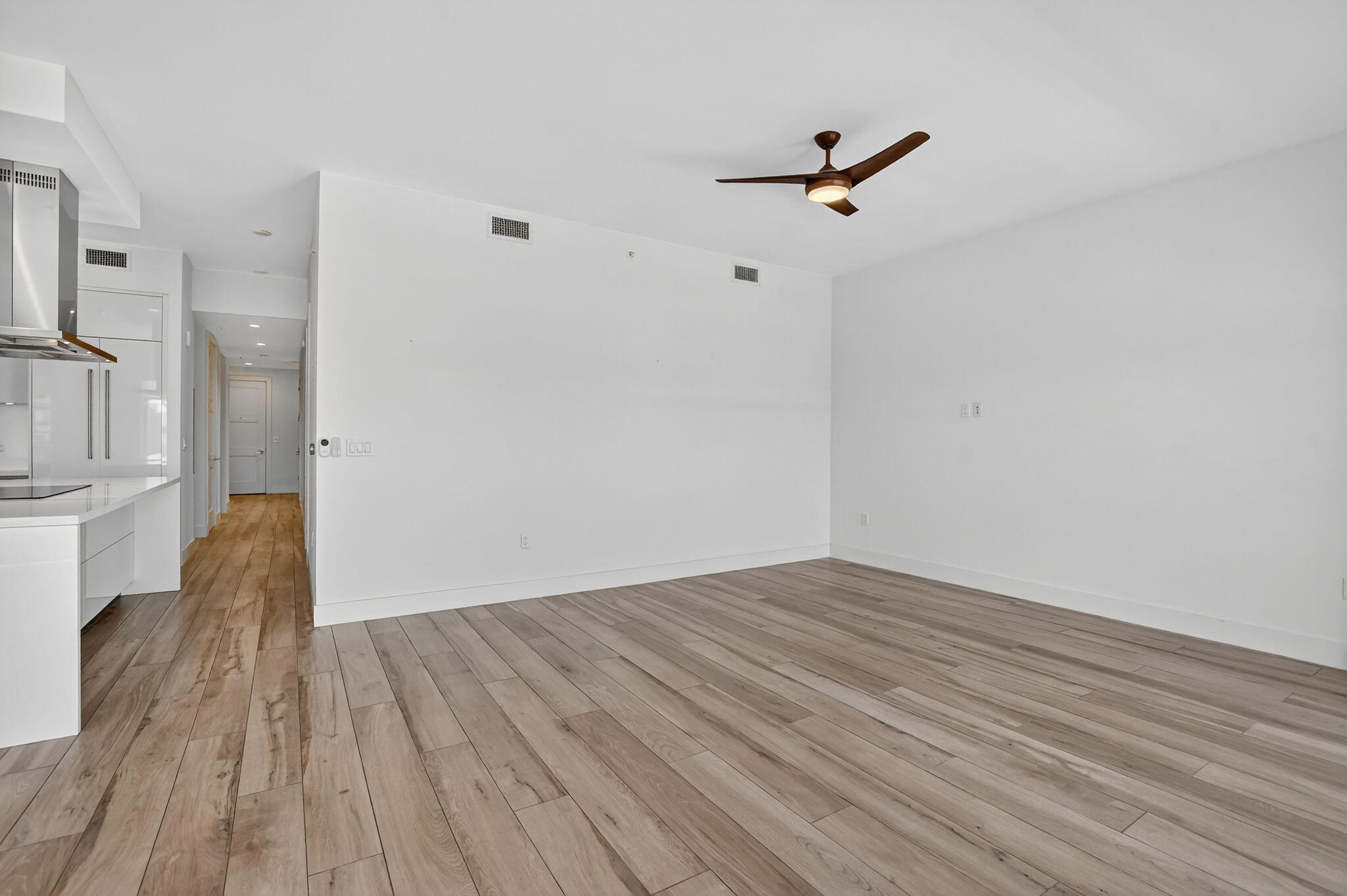 155 East Boca Raton Road, Unit 1014 Boca Raton, FL 33432 - Photo 5 of 62 a view of empty room with wooden floor and fan