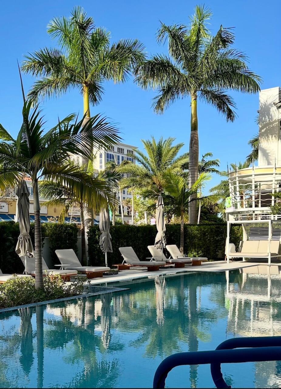 155 East Boca Raton Road, Unit 1014 Boca Raton, FL 33432 - Photo 54 of 62 a view of swimming pool with a table and chairs
