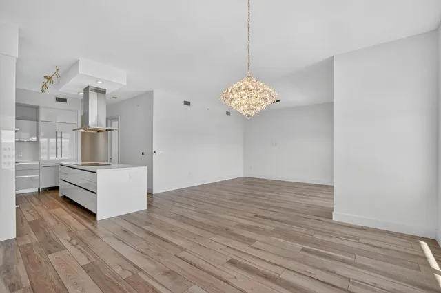 a kitchen with a stove and a wooden floor