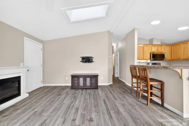 a view of kitchen with sink microwave and cabinets