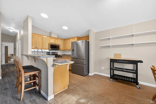 a kitchen with a refrigerator a stove and a sink