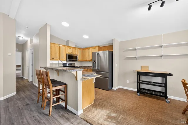 a kitchen with refrigerator and cabinets