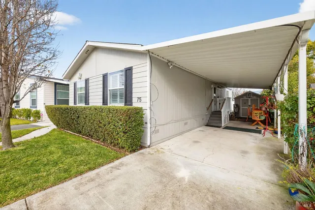 a view of a house with wooden fence