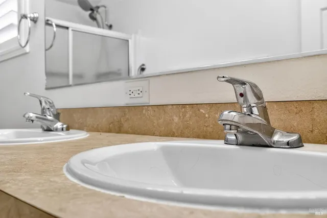 a front view of a house with a yard and potted plants