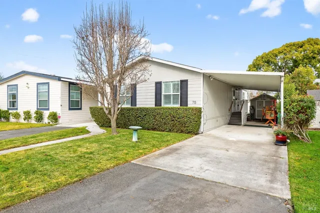 a front view of house with yard and green space