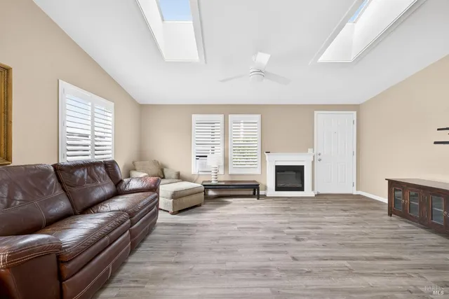 a living room with furniture flat screen tv and a fireplace