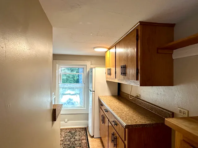 a kitchen with a sink stove and refrigerator
