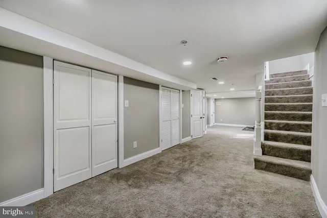 a view of an empty room with a ceiling fan