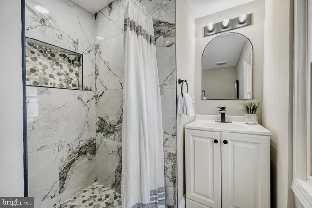 a bathroom with a sink and mirror