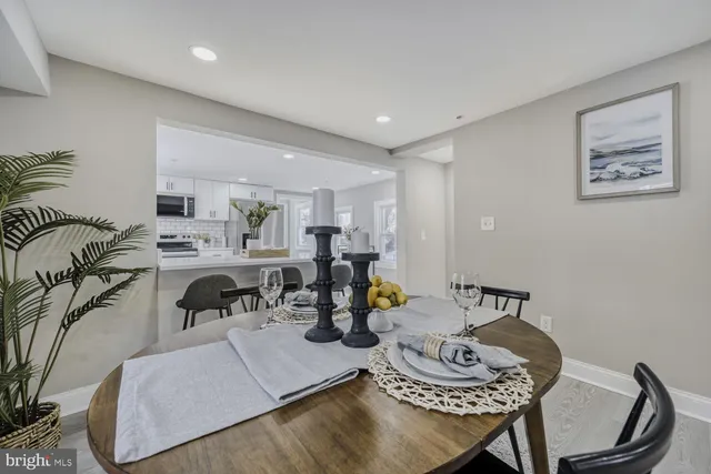 a living room with furniture and kitchen area