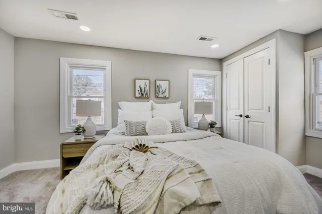 a bedroom with a large bed and a window