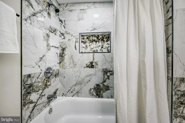 a bathroom with a bathtub and shower