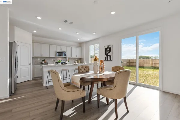 a kitchen with granite countertop a sink and a stove top oven with wooden floor