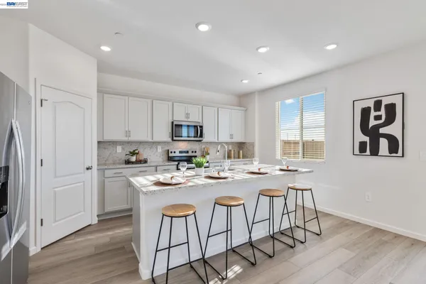 a kitchen with stainless steel appliances granite countertop a sink and a microwave