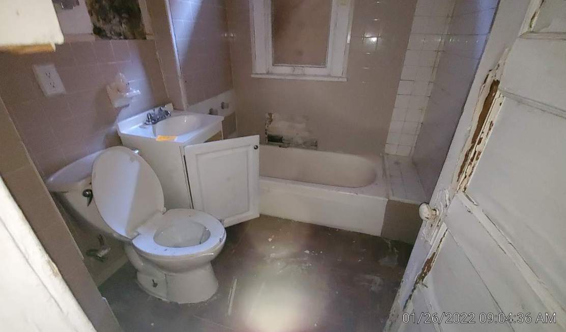 2706 East 78th Street Chicago, IL 60649 - Photo 5 of 10 a white toilet sitting next to a bath tub